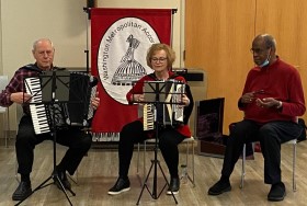 Peter DiGiovanni, Halina Banas-Jones, and Michael Jones perform at the February 2023 meeting.